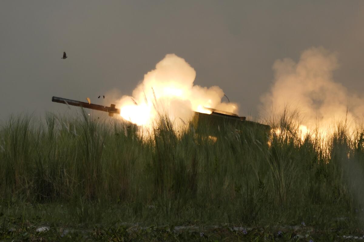 A U.S. M142 High Mobility Artillery Rocket System (HIMARS) fires a missile during annual combat drills between the Philippine Marine Corps and U.S. Marine Corps in Capas, Tarlac province, northern Philippines, Thursday, Oct. 13, 2022. Truck-mounted launchers blasted off rockets Thursday and U.S. stealth fighter jets streaked across the northern Philippine sky in a combat drill and latest display of American firepower in a region where Washington has tried to deter what it warns as China's growing aggression. (AP Photo/Aaron Favila)