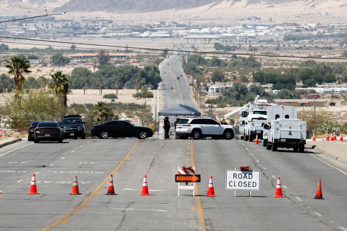 A road in Twentynine Palms is blocked by orange cones.
