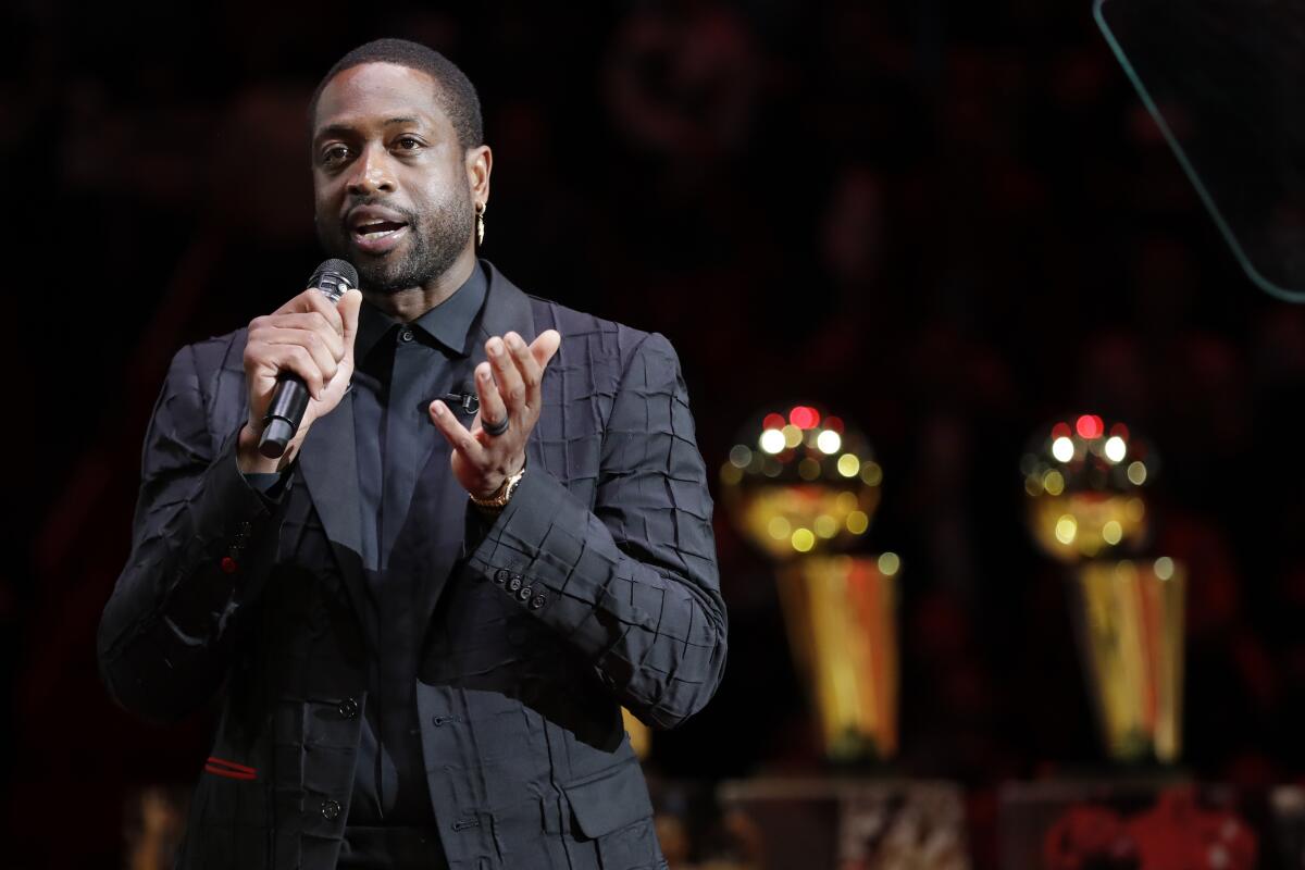 Former Miami Heat guard Dwyane Wade speaks during a jersey retirement ceremony.