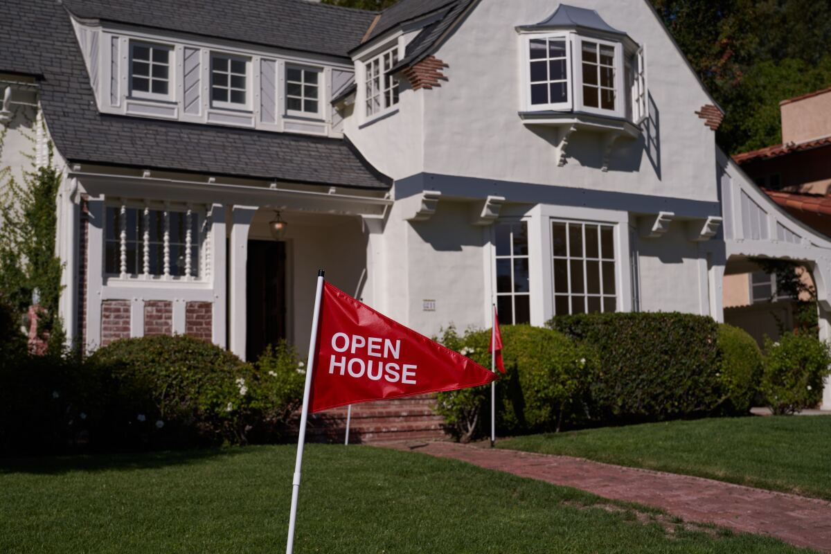 An 'open house' flag is displayed outside a single-family home