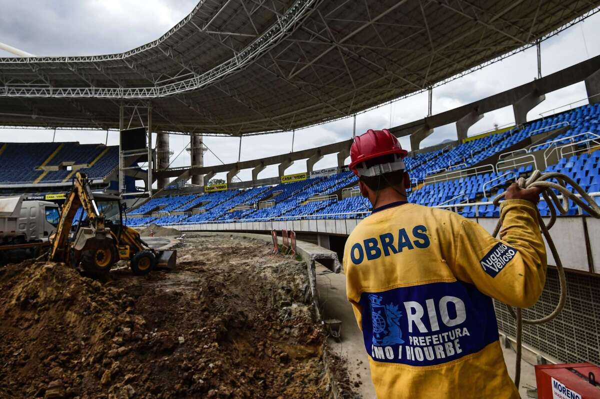 A worker helps refurbish Engenhao Olympic Stadium in Rio de Janeiro on Oct. 6, 2015, as preparations continue for next year's Summer Games.