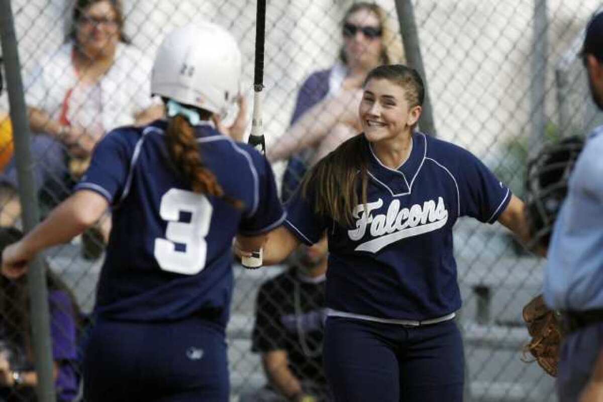 Crescenta Valley High's Hannah Cookson, left, receives a high five from Chloe Fairbrother in an 8-6 win over Hoover Thursday. Cookson hit a two-run homer in the sixth to end the scoring.
