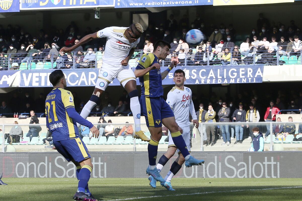 Napoli's Victor Osimhen, centre left, heads the ball to score, during the Serie A soccer match between Verona and Napoli, in Verona, Italy, Sunday, March 13, 2022. (Paola Garbuio/LaPresse via AP)