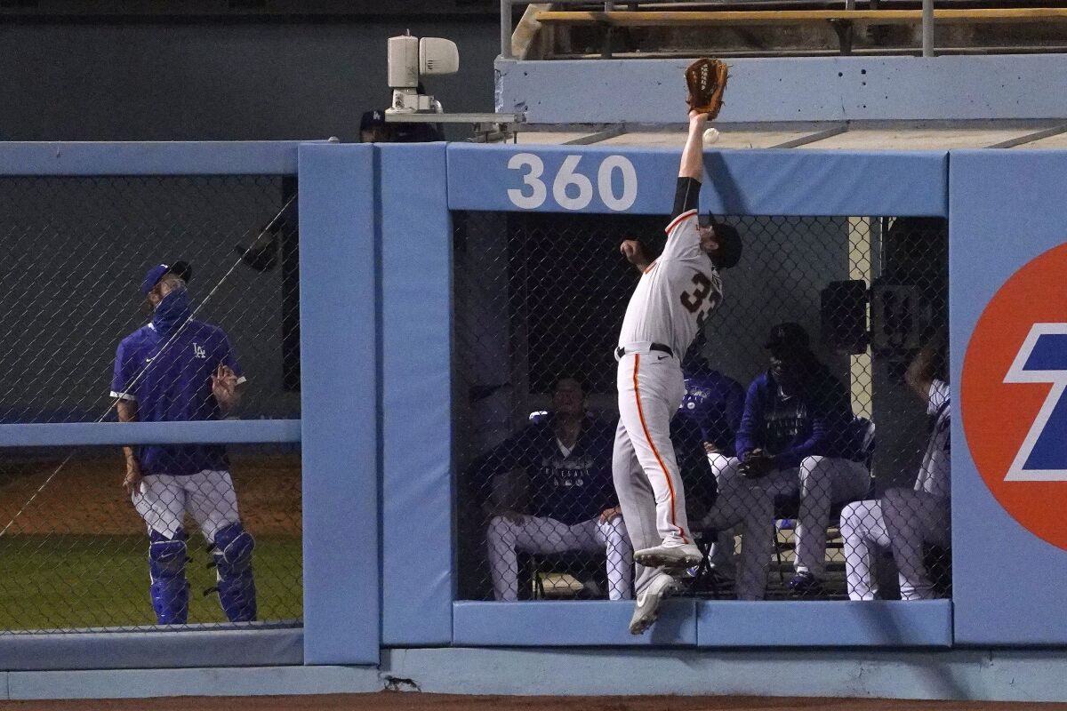 San Francisco Giants left fielder Darin Ruf can't reach a ball hit for a two-run home run by Los Angeles Dodgers' Will Smith during the fourth inning of a baseball game Friday, Aug. 7, 2020, in Los Angeles. (AP Photo/Mark J. Terrill)