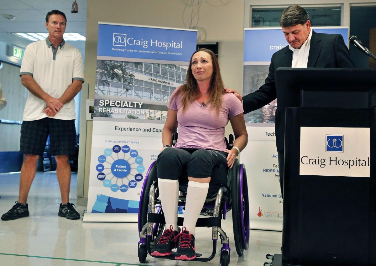 Olympic swimmer Amy Van Dyken-Rouen talks to the media on Aug. 14. She walked recently with the help of an exoskeleton.
