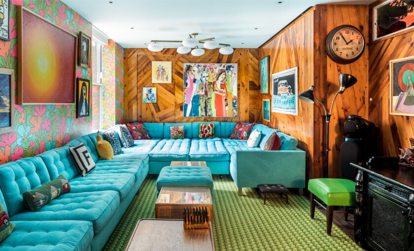 A colorful room dominated by a couch
