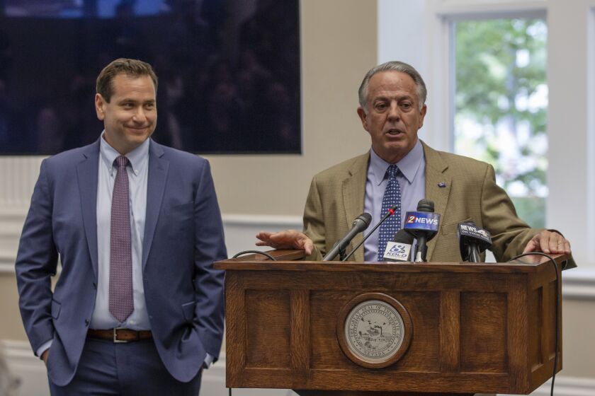 Nevada Governor Joe Lombardo, right, speaks before signing an election worker protection bill into law as Secretary of State Cisco Aguilar looks on at the old Assembly Chambers in Carson City, Nev., Tuesday, May 30, 2023. (AP Photo/Tom R. Smedes)