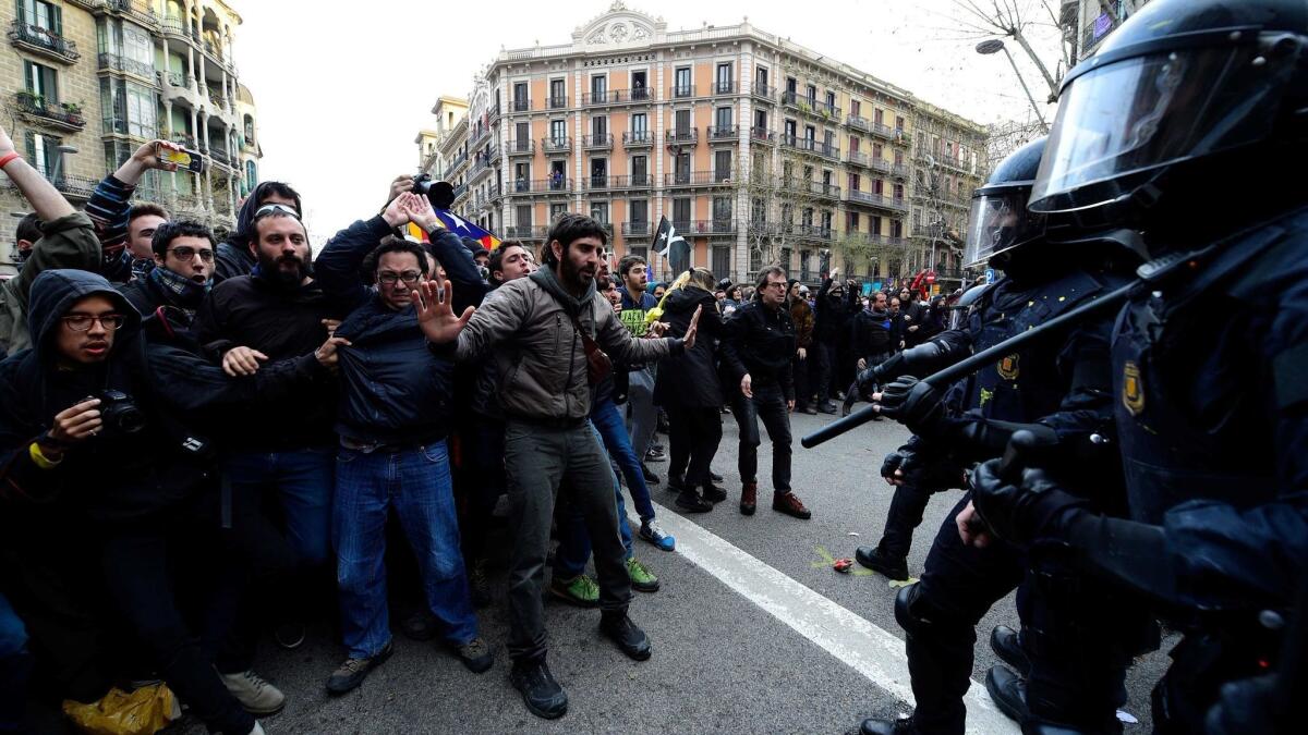 Protesters clash with riot police blocking the road leading to the central government offices during a demonstration in Barcelona on Sunday.