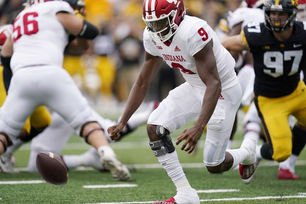 Indiana quarterback Michael Penix Jr. (9) fumbles the ball during the first half of an NCAA college football game against Iowa, Saturday, Sept. 4, 2021, in Iowa City, Iowa. (AP Photo/Charlie Neibergall)