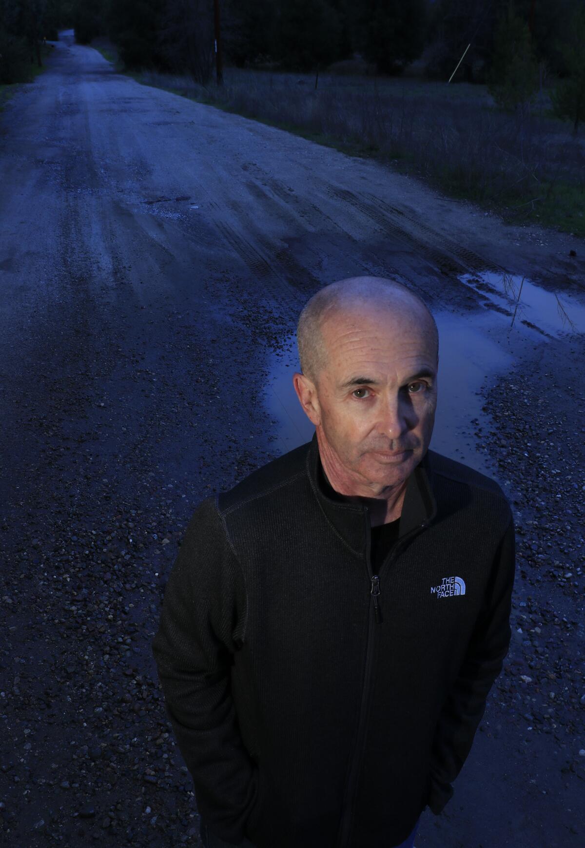 Novelist Don Winslow on a road in northeastern San Diego County that now leads to several homes and ranches but at one time led to a migrant camp and frequent Border Patrol activity.