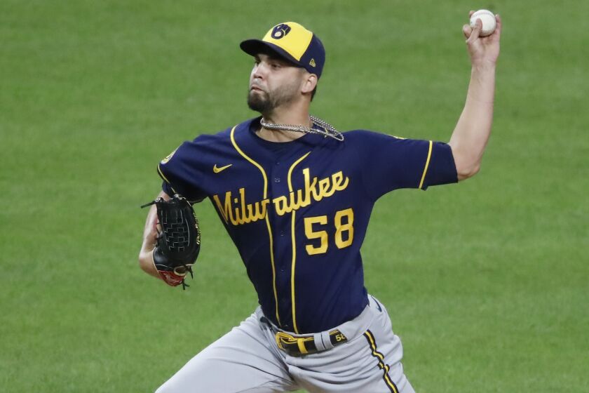 Milwaukee Brewers relief pitcher Alex Claudio delivers during the eighth inning of a baseball game.