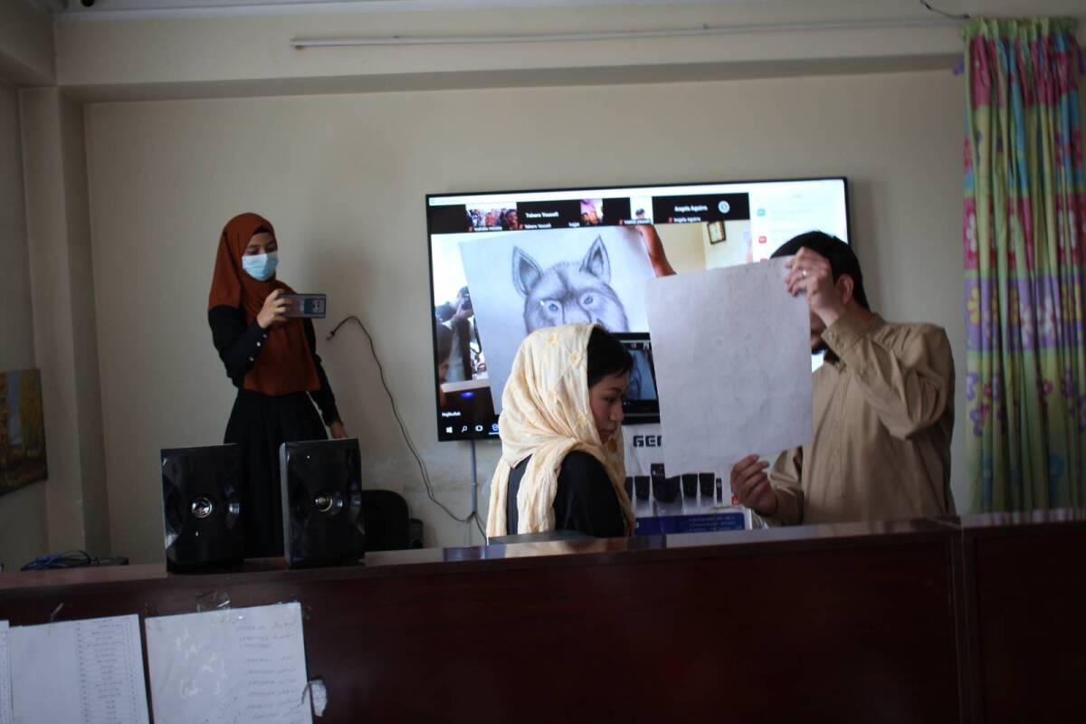 Students in Afghanistan, and a teacher, show their artwork