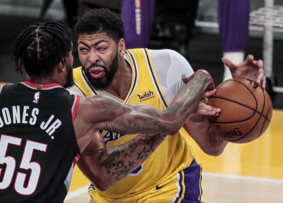 Trail Blazers forward Derrick Jones Jr. strips the ball from Lakers forward Anthony Davis during the second half.