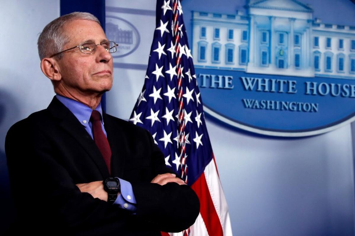 Dr. Anthony Fauci listens during a briefing about the coronavirus March 27.