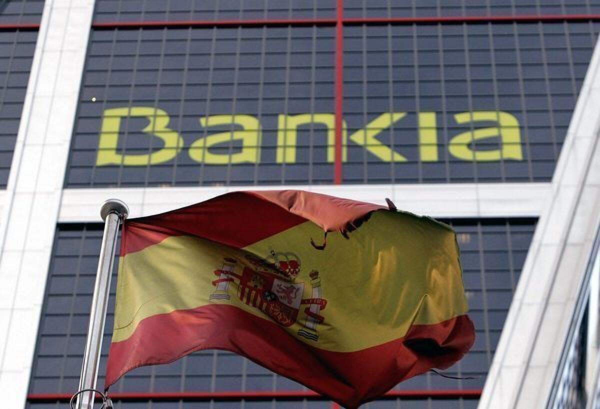 A Spanish flag flies next to Bankia headquarters in Madrid.