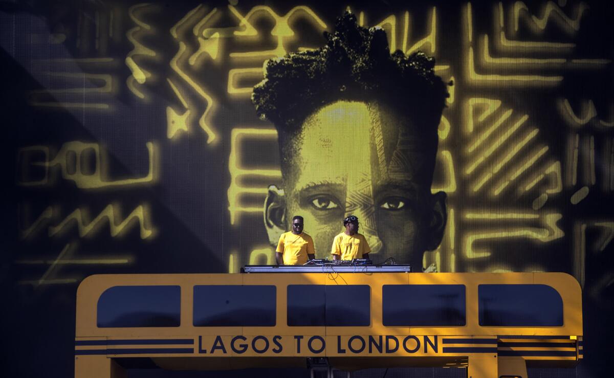 DJs with projection of Mr Eazi onstage at the Coachella Valley Music and Arts Festival.