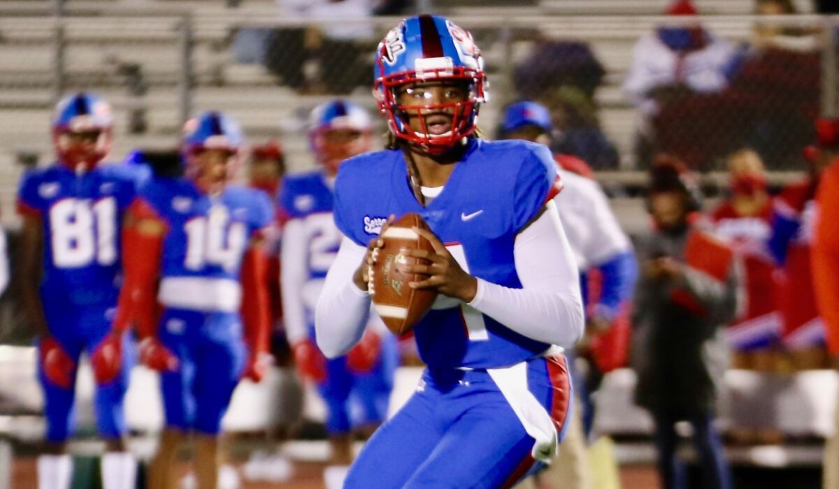 Gardena Serra quarterback Maalik Murphy drops back to pass in the first half of Friday night’s game against Long Beach Poly.