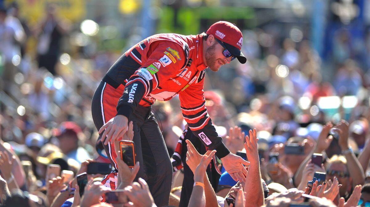Dale Earnhardt Jr. greets fans as he is introduced before a NASCAR Cup Series auto race at Homestead-Miami Speedway in Florida on Sunday.