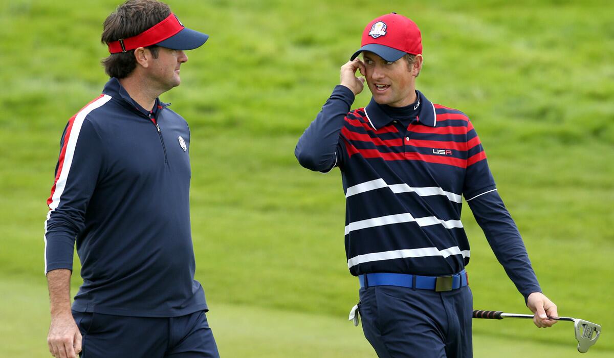 Bubba Watson, left, and Webb Simpson chat while walking the fairway of No. 3 during a practice round at Gleneagles.