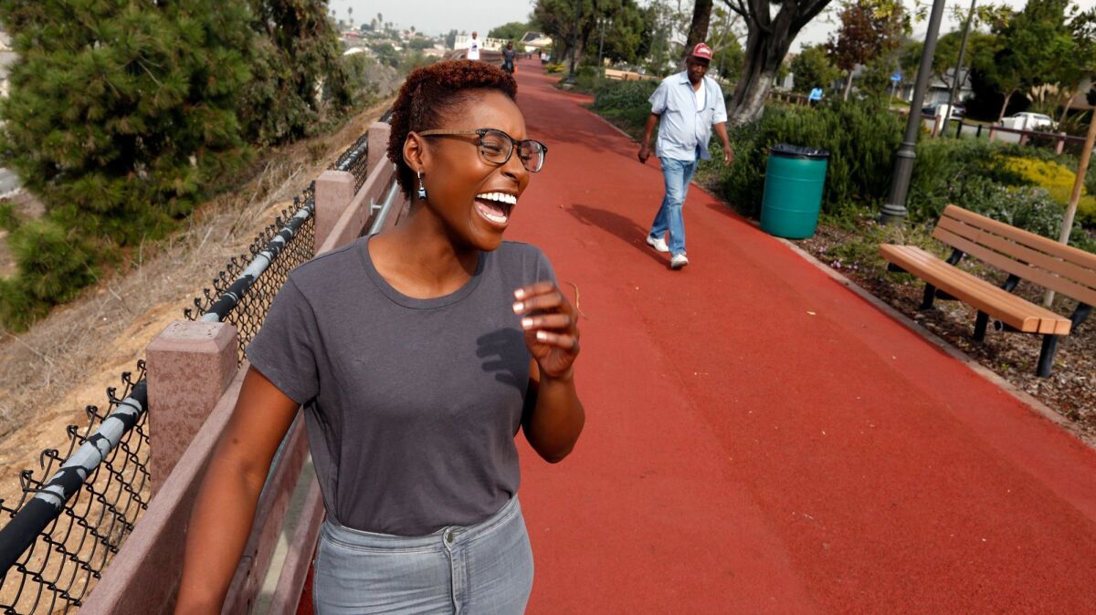 Issa Rae, creator and star of the HBO comedy series, "Insecure," enjoys a light moment while walking through View Park community in Los Angeles. Rae's show features the city of Inglewood and other areas in South Los Angeles.