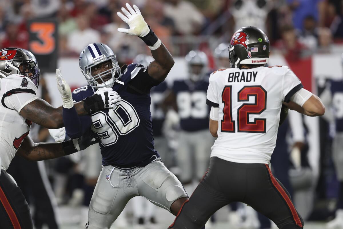 Dallas Cowboys defensive end DeMarcus Lawrence (90) pressures Tampa Bay Buccaneers quarterback Tom Brady (12) during the second half of an NFL football game Thursday, Sept. 9, 2021, in Tampa, Fla. (AP Photo/Mark LoMoglio)