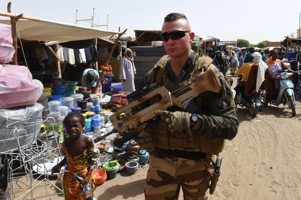 A French soldier of Operation Barkhane, an anti-terrorist operation in the Sahel, patrols at a market in Gao, northern Mali, on May 30.
