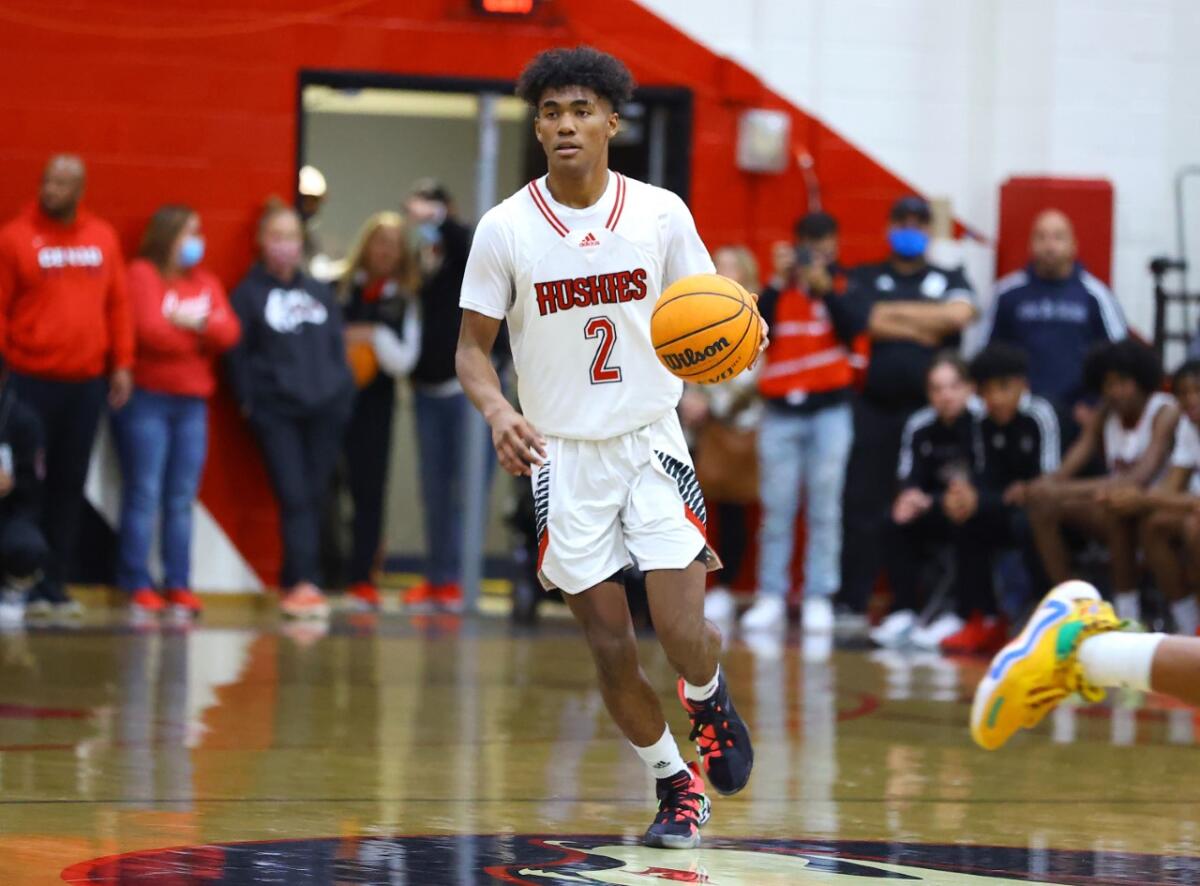 Point guard Donovan Dent brings the ball up court for Corona Centennial.