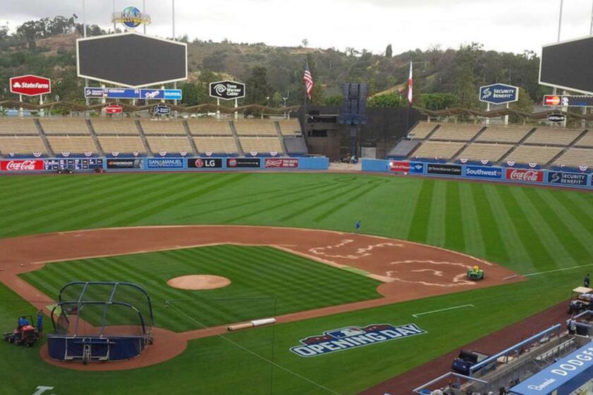 Crews prepare Dodger Stadium before the opening-day game on April 6.