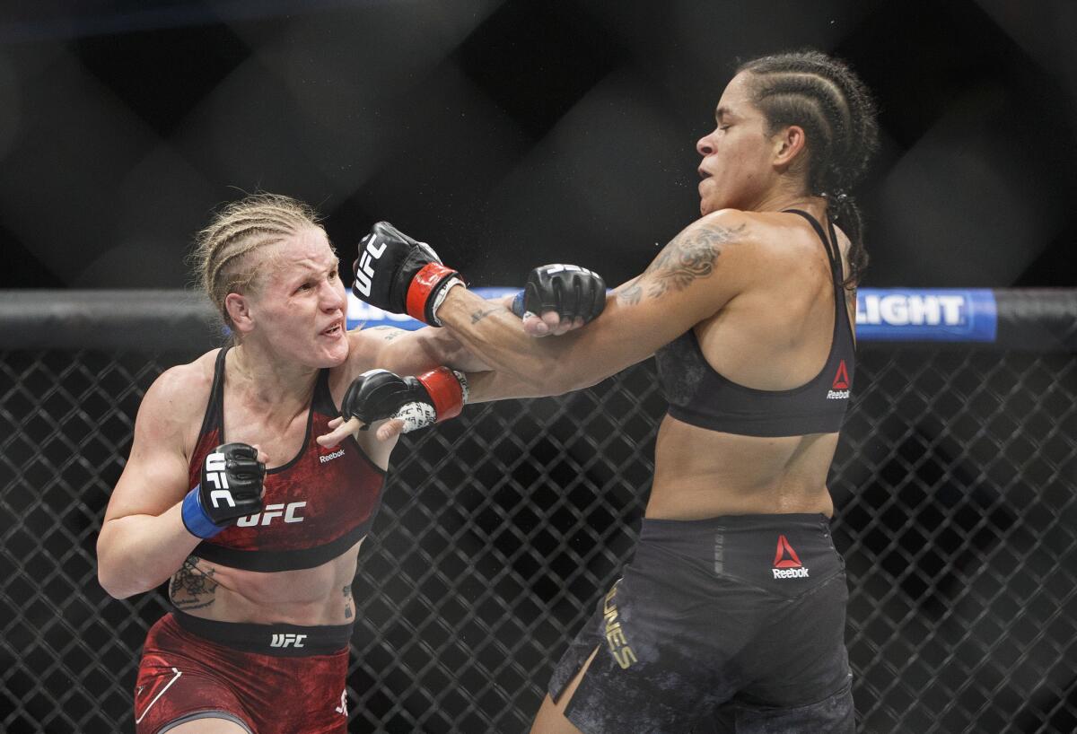 Amanda Nunes, right, blocks a punch by Valentina Shevchenko during their fight at UFC 215 on Sept. 9, 2017.