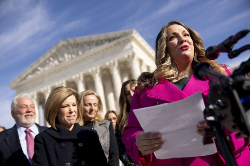 Lorie Smith, a Christian graphic artist and website designer in Colorado, right, accompanied by her lawyer, Kristen Waggoner of the Alliance Defending Freedom, second from left, speaks outside the Supreme Court in Washington, Monday, Dec. 5, 2022, after her case was heard before the Supreme Court. The Supreme Court is hearing the case of Smith, who objects to designing wedding websites for gay couples, that's the latest clash of religion and gay rights to land at the highest court. (AP Photo/Andrew Harnik)
