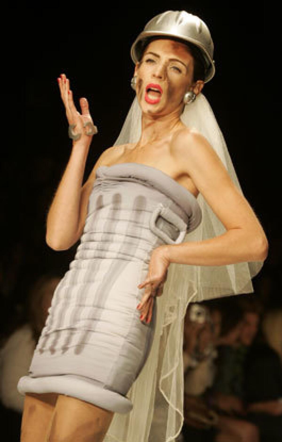 JEREMY SCOTT: A garbage can dress with accessories including screw-shaped earrings, hard hat and tulle veil redefine trashy bride.