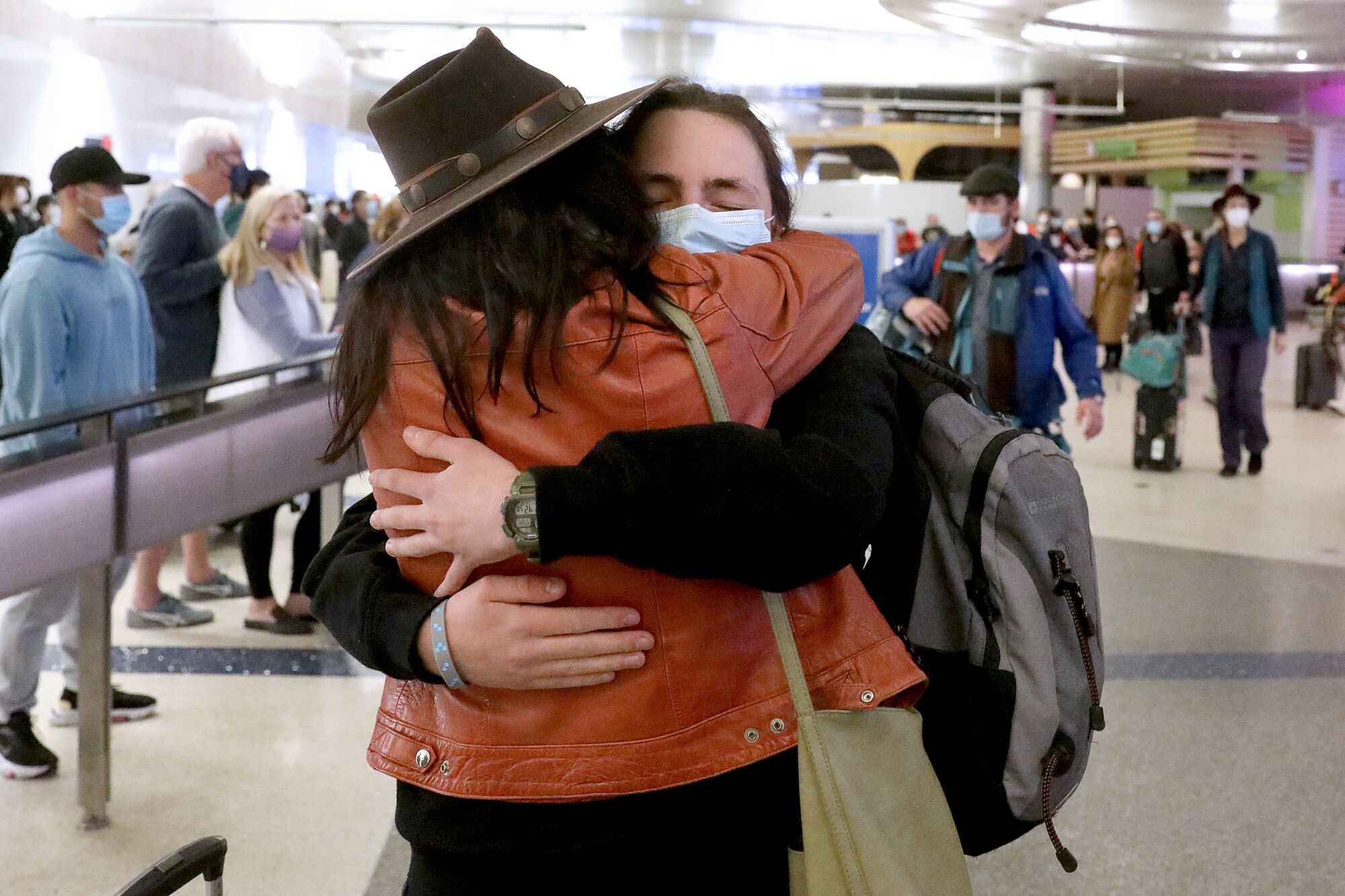 Tina Lord, left, greets her son Elliot Wrigley, visiting from London, at Tom Bradley International Terminal.