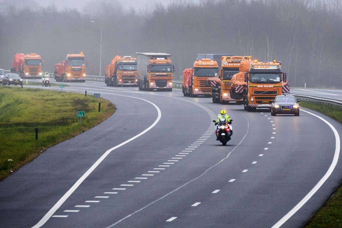 Trucks carrying the wreckage of Malaysia Airlines Flight 17, which crashed in Ukraine on July 17, en route Tuesday to the Gilze-Rijen air force base in The Netherlands.