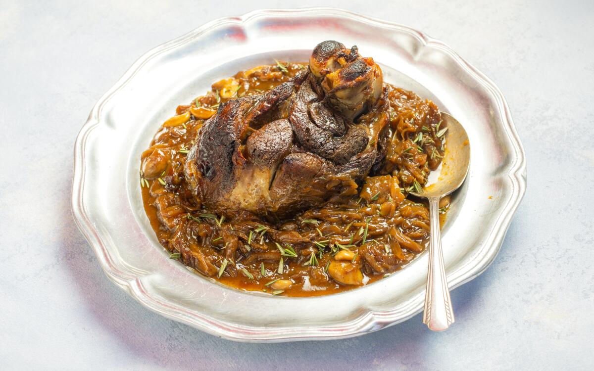 Braised lamb surrounded with vinegar- and rosemary-infused caramelized onions.