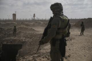 Israeli soldiers take up positions next to an entrance of a tunnel which the military says Hamas militants used in the southern Gaza Strip, about a 100 meters from the Philadelphi Corridor along the border with Egypt, during a ground operation on Friday, Sept. 13, 2024. (AP Photo/Leo Correa)