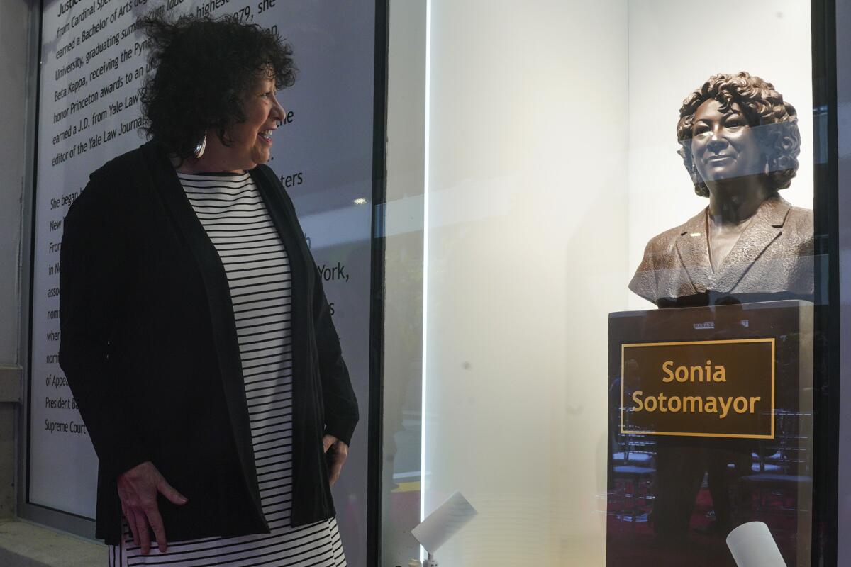 Supreme Court Justice Sonia Sotomayor reviews a statue of herself after its unveiling at Bronx Terminal Market, Thursday, Sept. 8, 2022, in New York. (AP Photo/Bebeto Matthews, Pool)