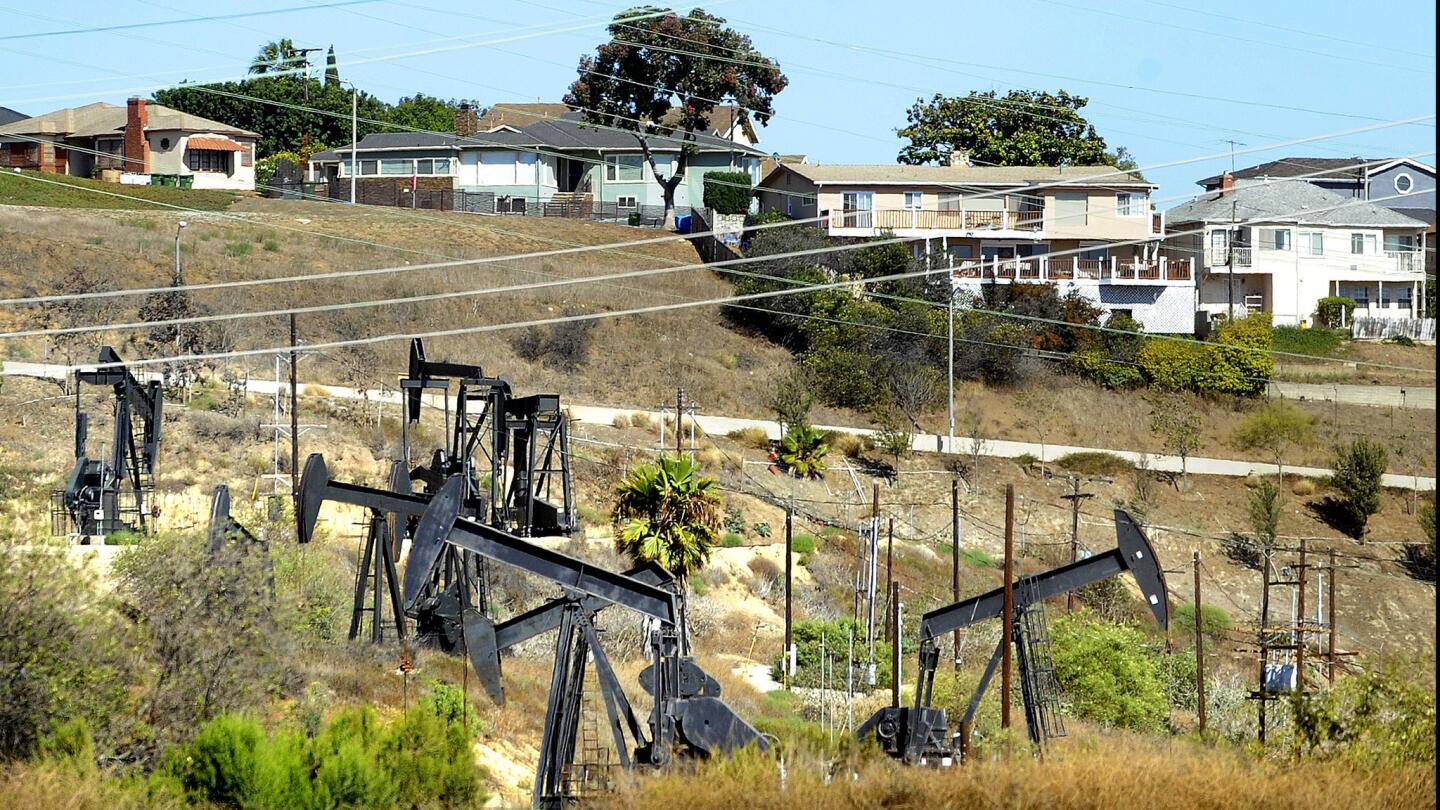 Oil wells operate near homes in Los Angeles on Aug. 4, 2015.