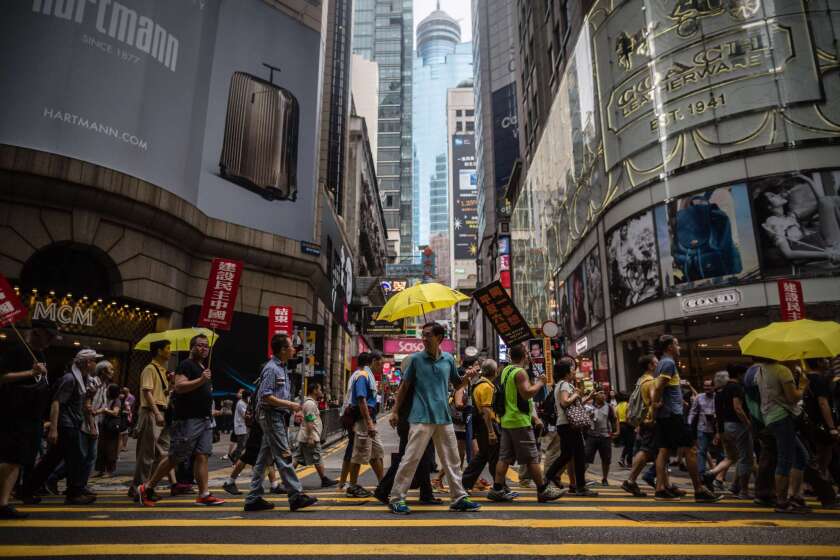 Protesters carry yellow umbrellas, a symbol of Hong Kong's pro-democracy movement, as they attend a rally in Hong Kong on May 31 to commemorate the 1989 crackdown at Tiananmen Square in Beijing, prior to the incident's 26th anniversary on June 4.