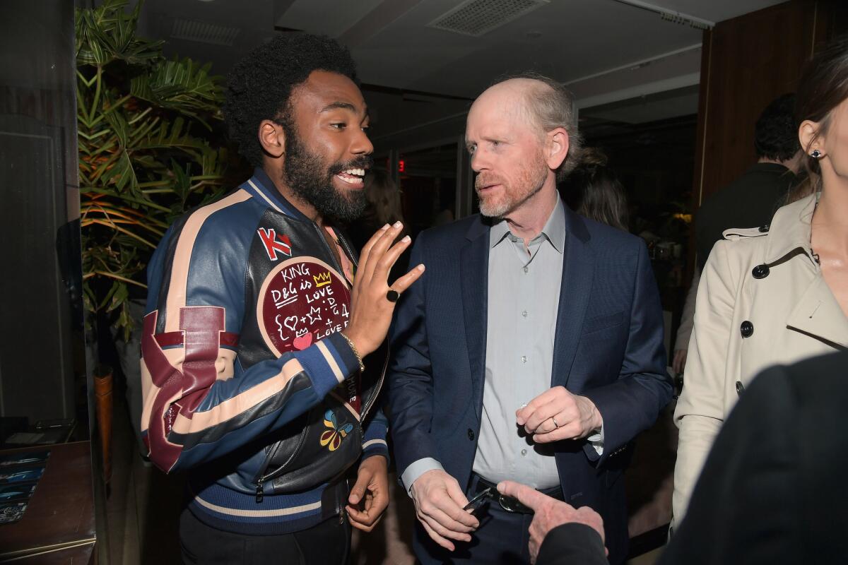 Donald Glover, left, and Ron Howard catch up at Esquire's "Mavericks of Hollywood" party.