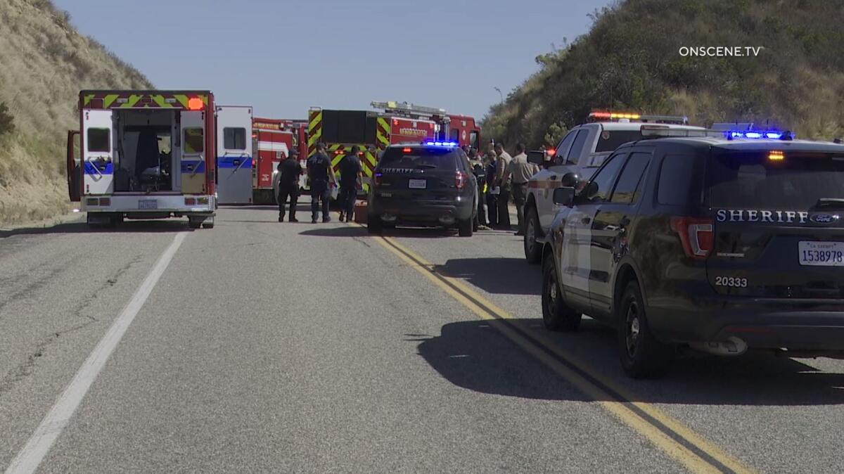 Paramedics and other respond to Skyline Truck Trail in Jamul on Tuesday morning after a man reportedly sprayed three deputies with bear deterrent, then stabbed a police dog, a sheriff's official said.