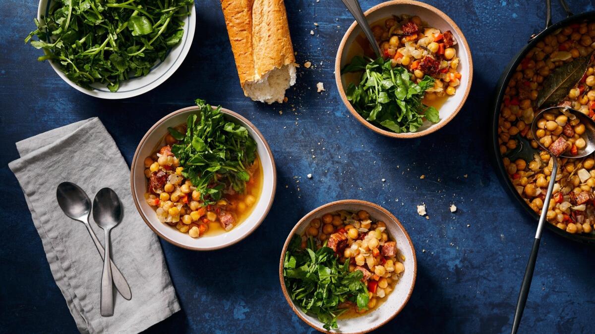 Canned chickpeas, baked in chicken broth with aromatics, are served up warm with bracing, crunchy watercress dressed with lemon. Food styling by Ben Mims, with Julie Giuffrida. Shot at Proplink Tabletop Studio in downtown Los Angeles.