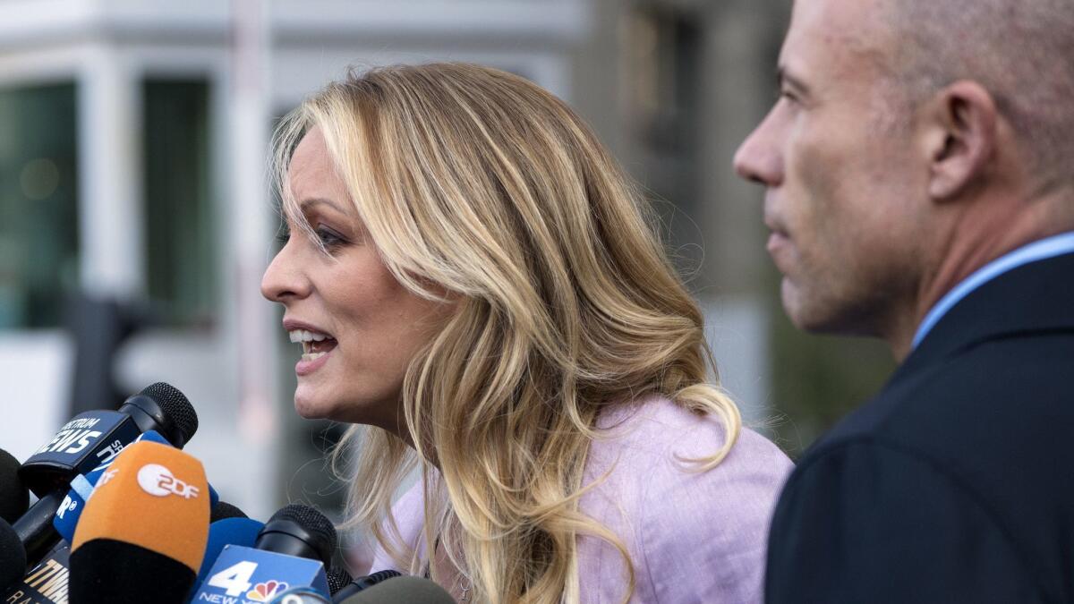 Stormy Daniels, seen with her lawyer, Michael Avenatti, alleges she had an affair with President Trump more than a decade ago.