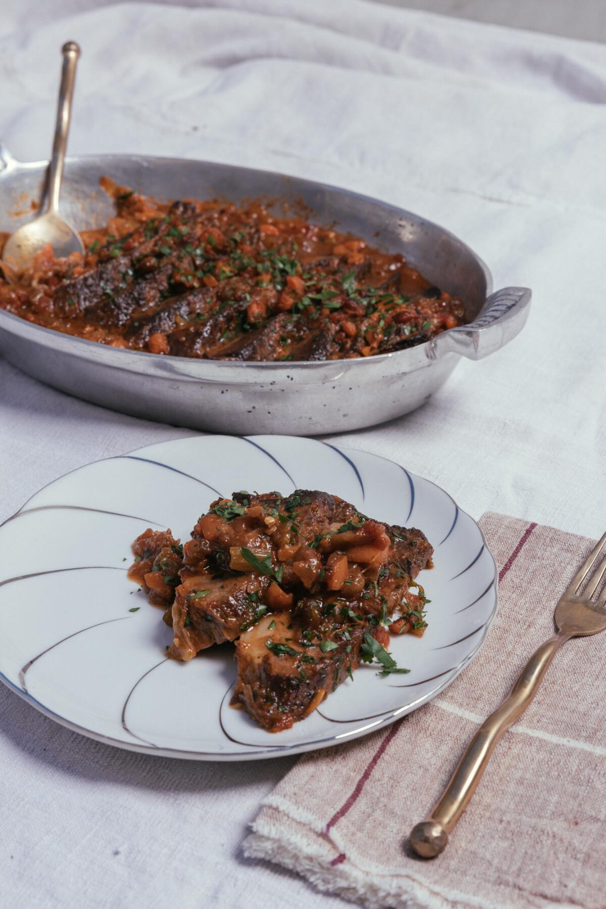 A brisket dish, in the pot and on a plate.