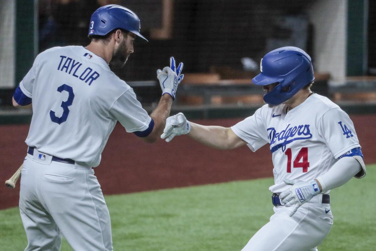 Dodgers second baseman Kiké Hernández, right, celebrates with teammate Chris Taylor after hitting a home run.