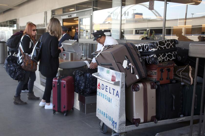 Passengers check their luggage at LAX.