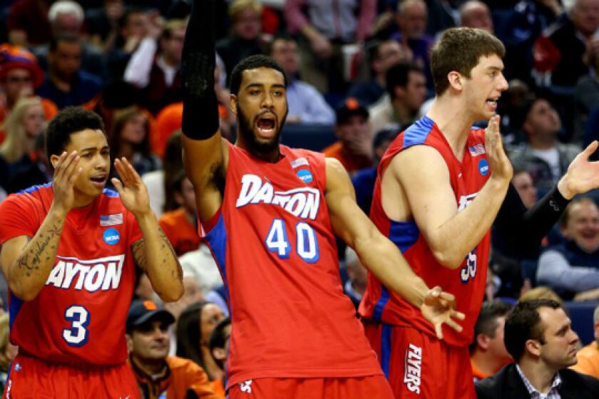 Dayton's Devon Scott, left, and Kyle Davis react during the Flyers' 55-53 upset win over Syracuse in the third round of the NCAA tournament Saturday.