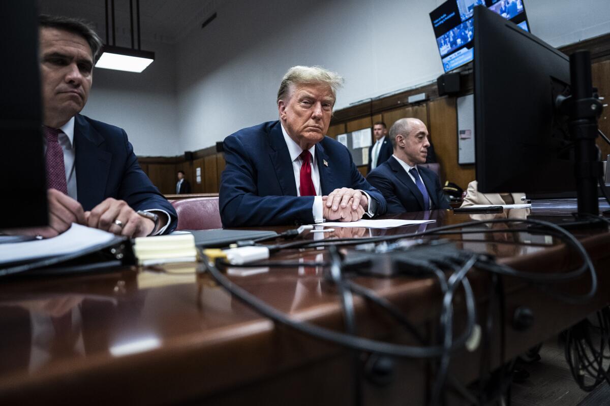 Former President Trump sits with his legal team in New York criminal court.