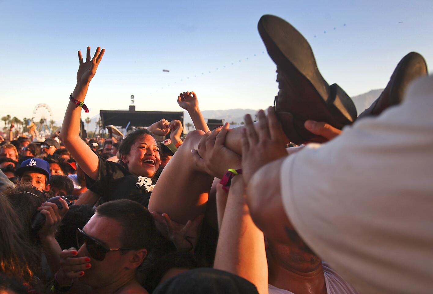 Concert goers are pulled from the crowd by security officers after being packed in dangerously tight as Death from Above 1979 perform at the Coachella Valley Music and Arts Festival, 2011.
