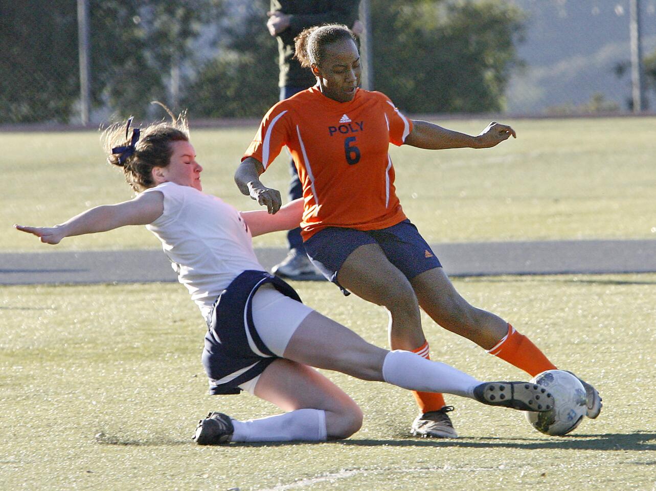 Flintridge Prep's Katherine Pinney sweeps the ball from Pasadena Poly's Noel Askins during a match on Monday, January 14, 2013.