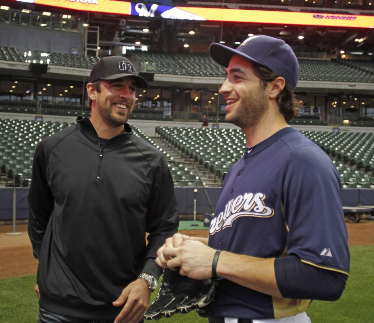 Green Bay Packers quarterback Aaron Rodgers, left, shares a laugh with friend and Milwaukee Brewers outfielder Ryan Braun in 2011.